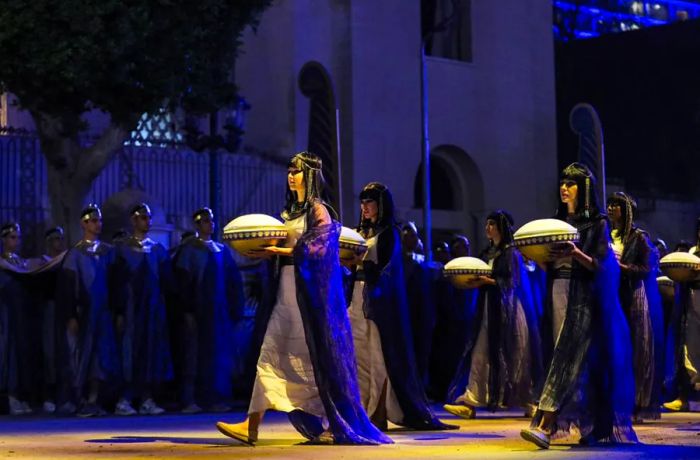 Actors in ancient Egyptian attire lead the way at the start of the grand procession of 22 royal mummies departing from the Egyptian Museum in Cairo's Tahrir Square.