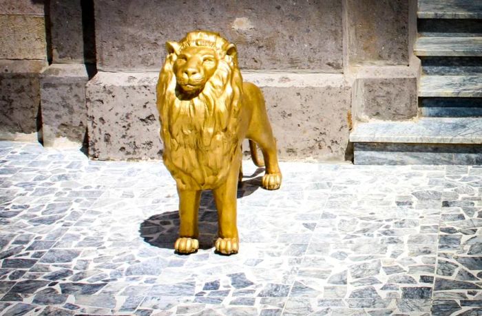 The entrance to the Throne House is guarded by symbolic lions, standing as sentinels to the power within.