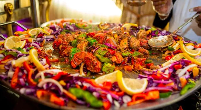 Rasoi’s sizzling chicken platter is not only a favorite but also a vibrant feast for the eyes.