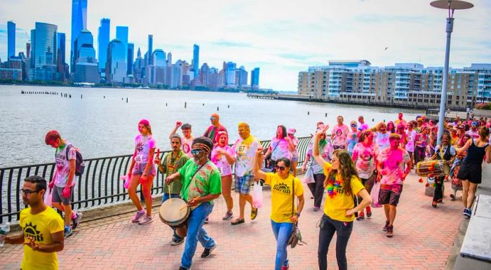 One of the nation’s most dynamic Indian neighborhoods thrives just across the river from Manhattan. Pictured is the 2019 Surati Holi Hai Color Walk.