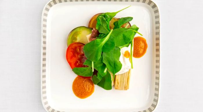 The heirloom tomato salad featuring cured ham, palm hearts, AeroFarms Arugula, and spiced tomato dressing is now being served on flights from Newark to Singapore.