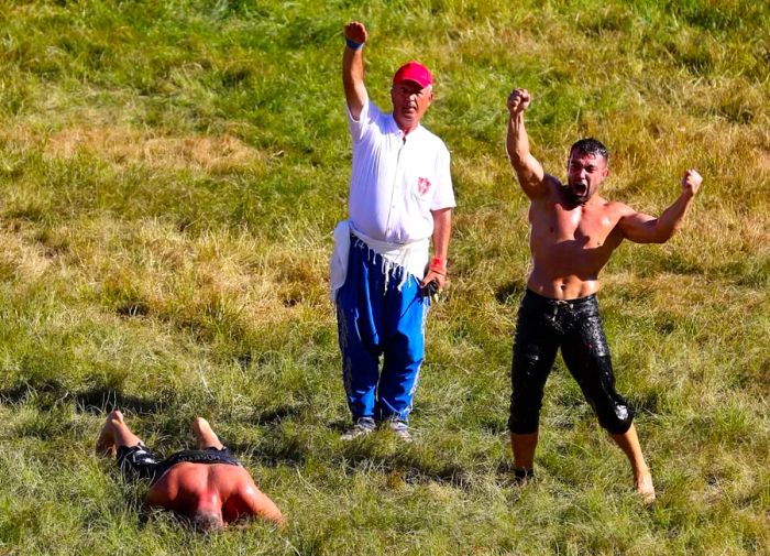 To win, wrestlers must successfully toss their slippery opponent to the ground.