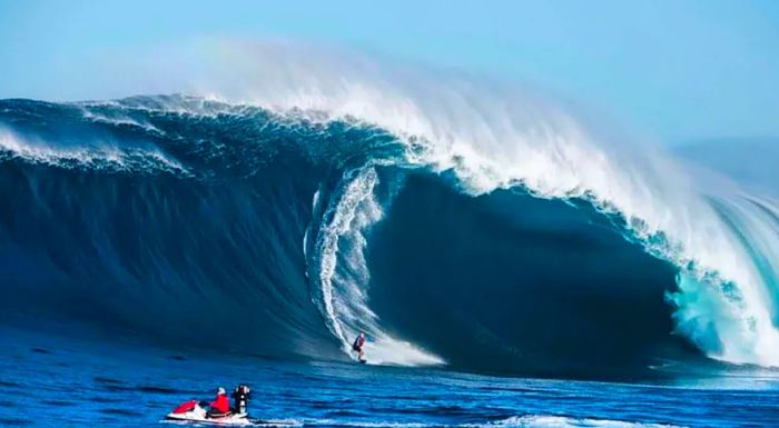 Griffiths is shown here surfing at Pedra Branca on his board.