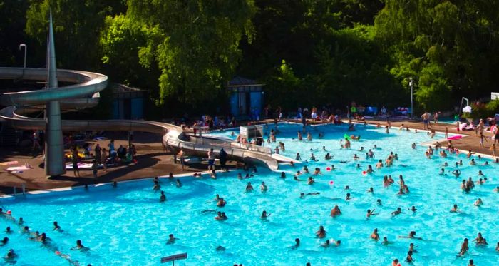 People enjoying a swim in a public pool in Berlin’s Neukoelln district.