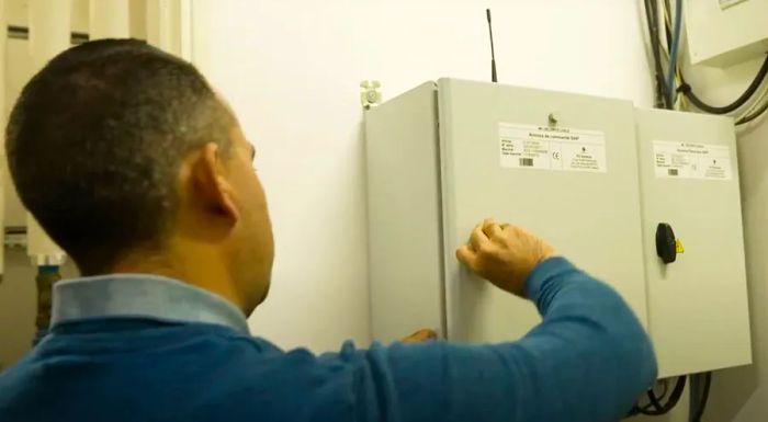 Stéphane Mollet, a technician from the Maison Laffitte town hall, opens a cabinet filled with the electronics that power the alert system.