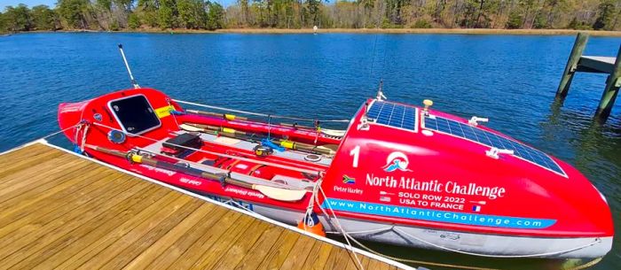 The ocean rowing boat is equipped with storage, a sleeping cabin, and solar panels.