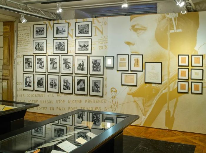 The exhibition features photographs, poems, and newspaper clippings related to the book.