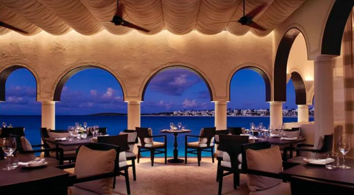 Indulge in fine dining set against the backdrop of a stunning Caribbean paradise.