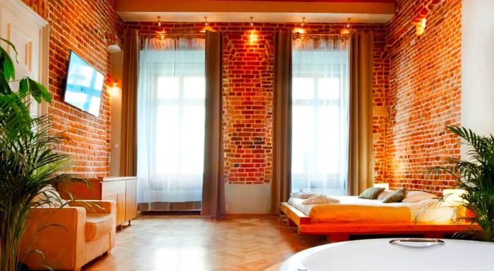 The apartments at Aparthotel Stare Miasto feature rustic brick walls and charming beamed ceilings, creating a cozy yet stylish atmosphere.