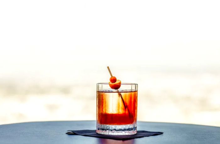 Spire 73’s Kumquat Old Fashioned is made with Suntory Japanese whisky, offering a unique twist on a classic favorite.