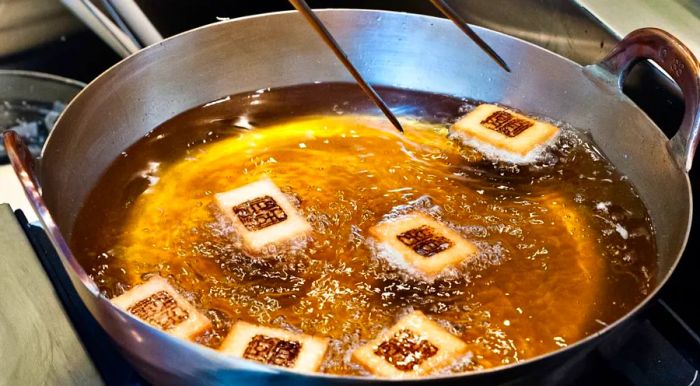 At Tempura Endo, guests are treated to the sight of shrimp toast turning a perfect golden brown, among other delicate tempura creations.