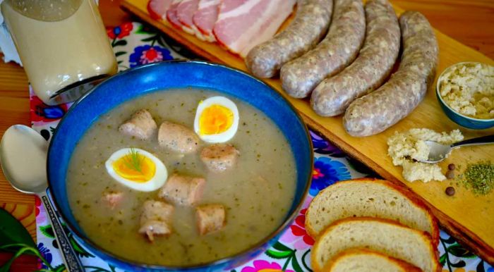 Żurek, a traditional Polish sour rye soup, is typically served with sausage, a hard-boiled egg, and a spicy kick of horseradish.