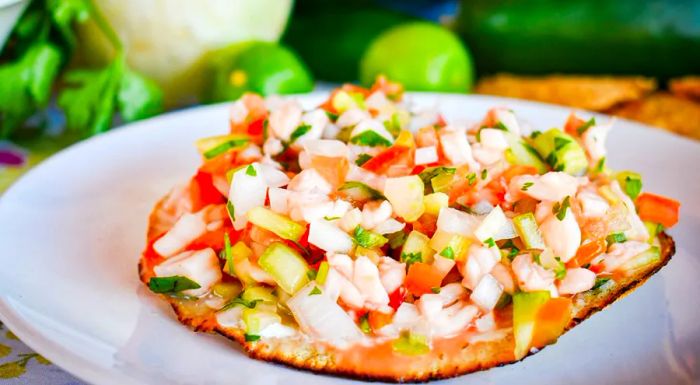 A popular seafood dish is ceviche made with white fish, typically served on crispy tostadas.