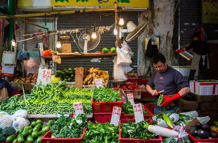 A vendor selling fresh vegetables at Graham Street, one of Hong Kong's oldest wet markets.