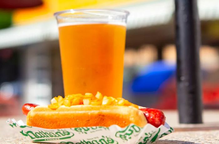 A summer trip to Coney Island almost always includes hot dogs, and often a cold beer to accompany them.