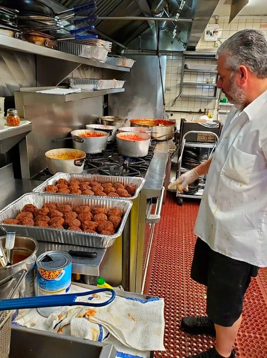 Rao's Executive Chef Dino Gatto preparing a batch of the restaurant's iconic meatballs.