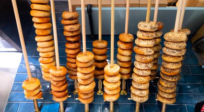 At Button & Co., bagels are neatly arranged on wooden poles, making it easy for staff to quickly assess what’s available for customers.