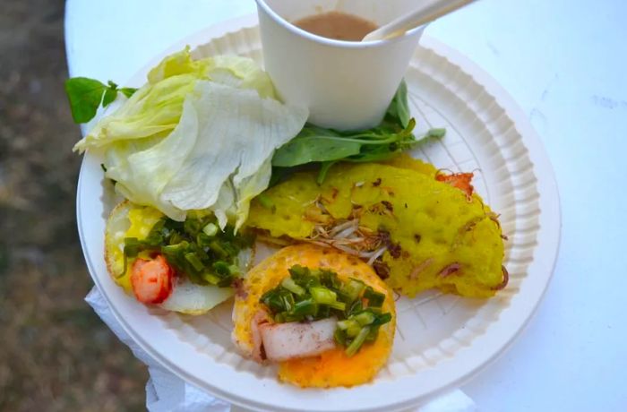 Banh Xeo is a savory Vietnamese pancake, crispy on the outside and filled with a delicious mix of ingredients.