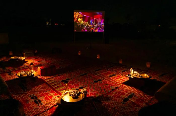 Guests can relax on comfortable rugs while watching classic films at the resort’s open-air cinema.