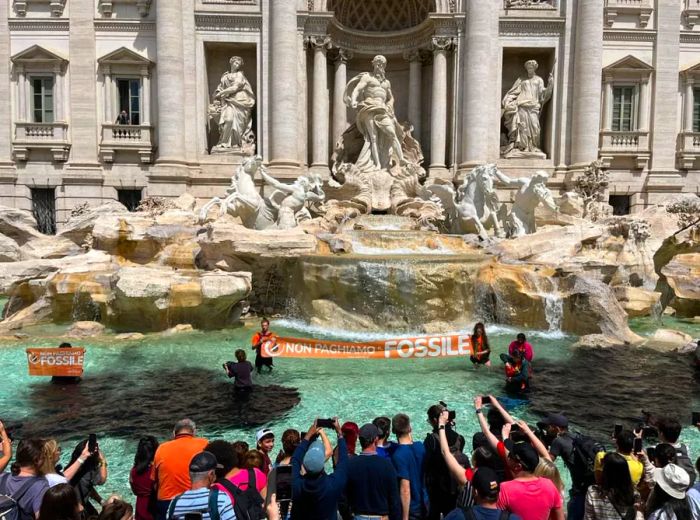 Activists from the climate group Last Generation were seen standing inside the Trevi Fountain in Rome.