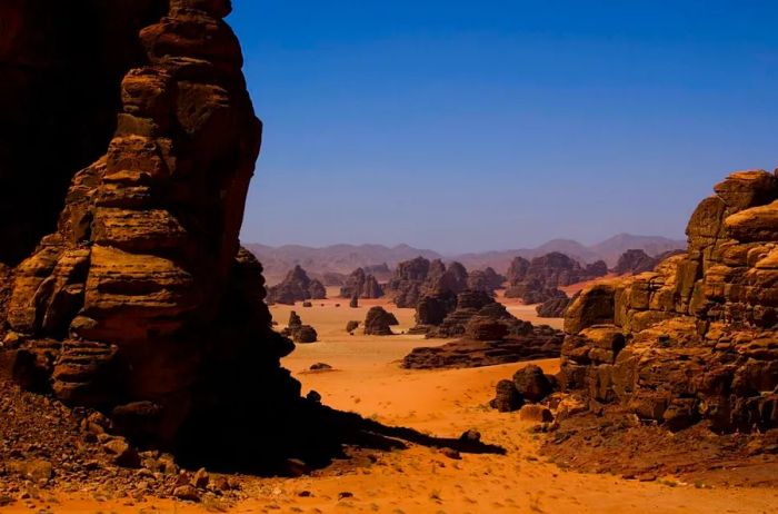 The vast Hisma desert, with its crimson sands and towering sandstone formations, extends into Jordan.