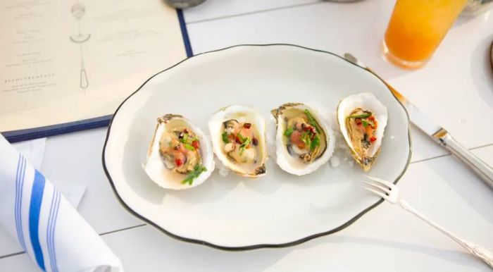 This floating oyster bar in New York City serves up inventive oyster dishes, perfect for enjoying with a stunning view.