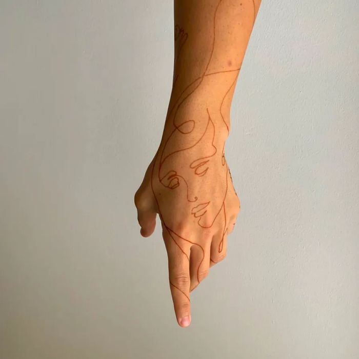 Khamissa's minimalist henna art features elegant line drawings of faces, flowers, and natural landscapes.