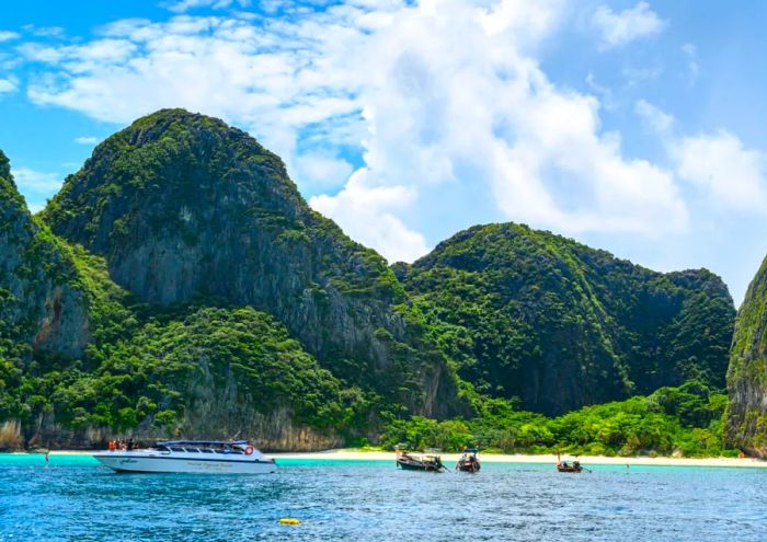 A photo taken on October 4, 2019, shows boats at the boundary line of Maya Bay, as set by the Thai National Park, Wildlife, and Plant Conservation Department. The beach remains off-limits.