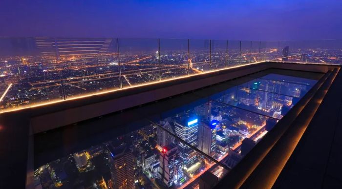 The Mahanakhon SkyWalk boasts a glass floor that projects over the skyscraper’s edge, giving visitors a thrilling view from above.