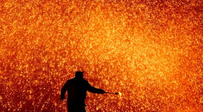 Da tie hua, or 'hit iron flower,' is a unique Lantern Festival tradition where a blacksmith hurls molten iron to create a dazzling display of sparks.