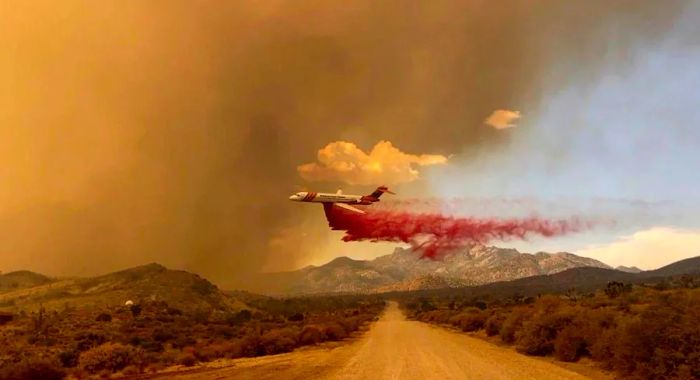 A fire retardant drop is made by a tanker over the York Fire in the Mojave National Preserve this past Saturday.