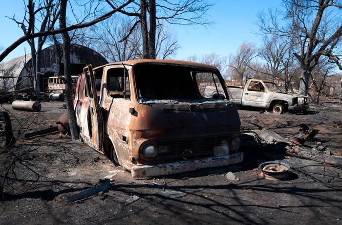 The scorched remains of vehicles lie behind a shop destroyed by the Smokehouse Creek fire as it swept through the Texas Panhandle on March 2, 2024.