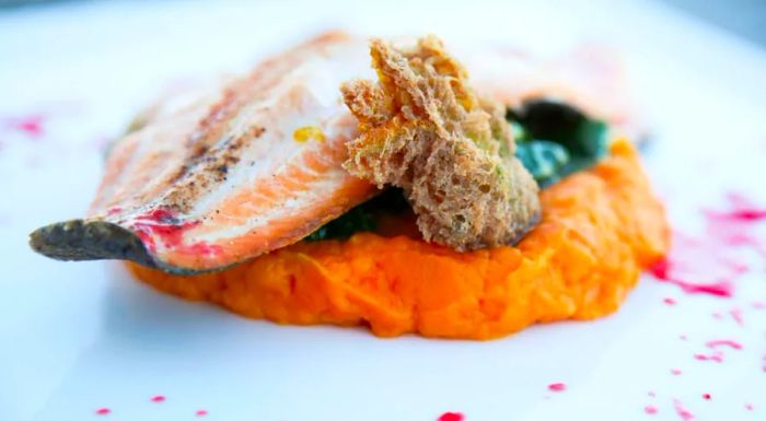 The pan-seared New Mexico trout at Pueblo Harvest Café is a signature dish, capturing the essence of local flavors and regional culinary techniques.