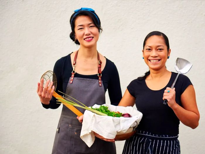 Indonesian chef Siska Silitonga (right) stands with Malaysian chef Tracy Goh (left).