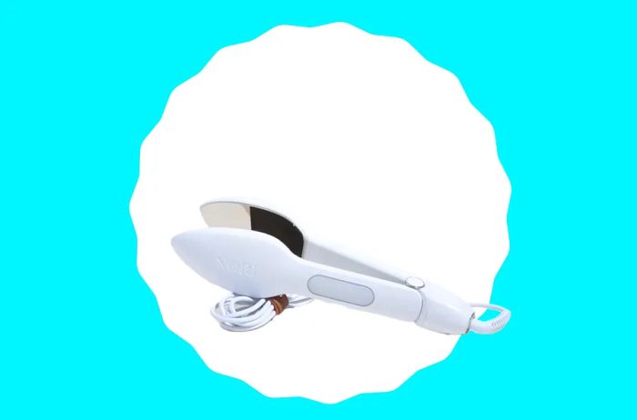 Compact white travel iron that doubles as a set of tongs for easy clothing care on the go.