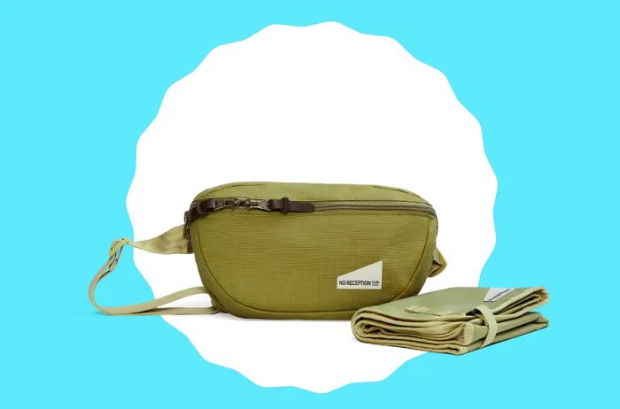 A green fanny pack diaper bag, perfect for hands-free convenience when traveling with kids.