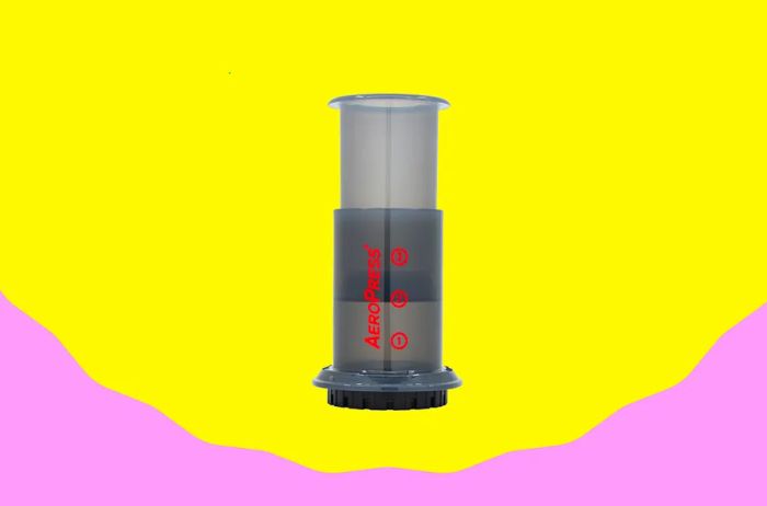 A gray AeroPress coffee maker