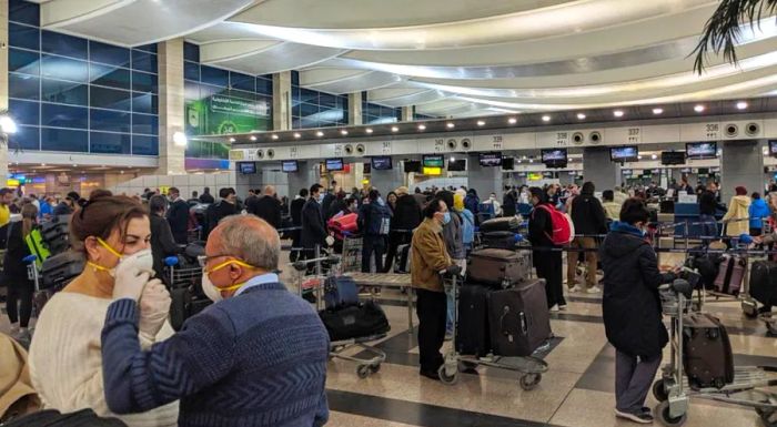 The check-in process was crowded, with most passengers wearing masks.