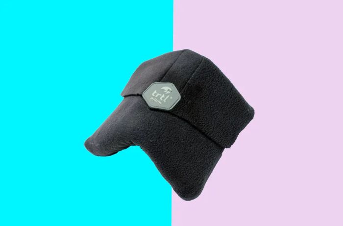 A folded dark gray Trtl pillow.