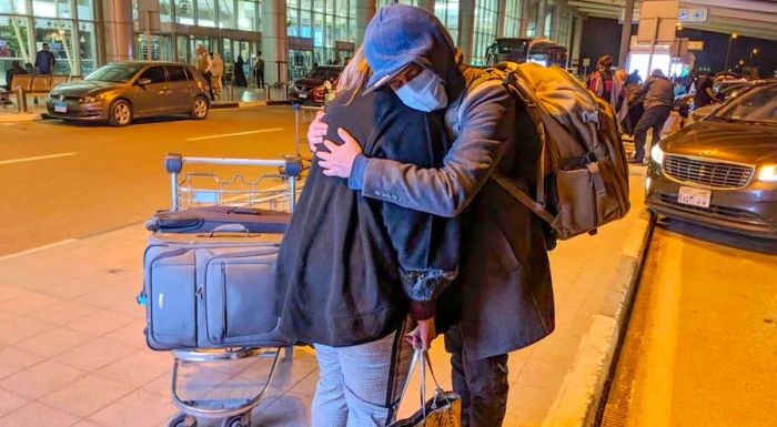 Eihab Boraie shares a tearful hug with his mother at Cairo’s international airport before his departure.