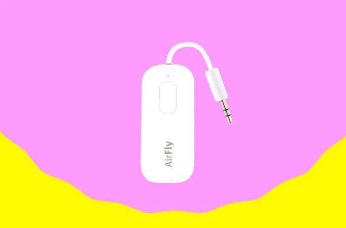 A compact white Bluetooth device that plugs directly into a headphone jack.