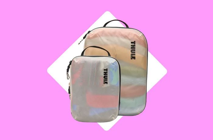 Two semi-transparent white Thule compression packing cubes in different sizes