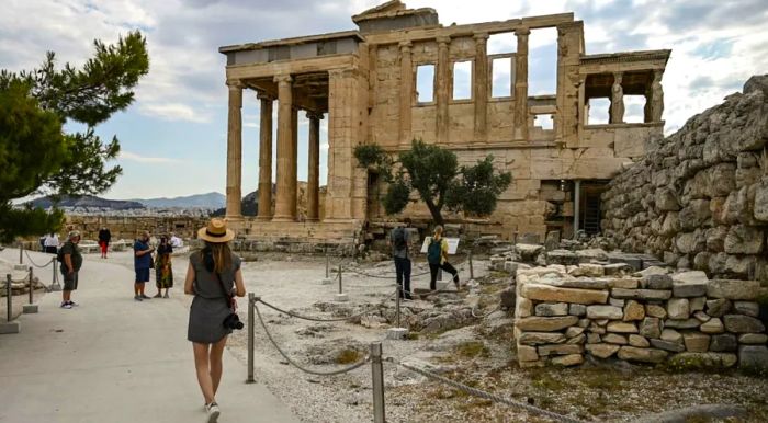 Tourists make their way toward the Erechtheion on the Acropolis in Athens on June 4.