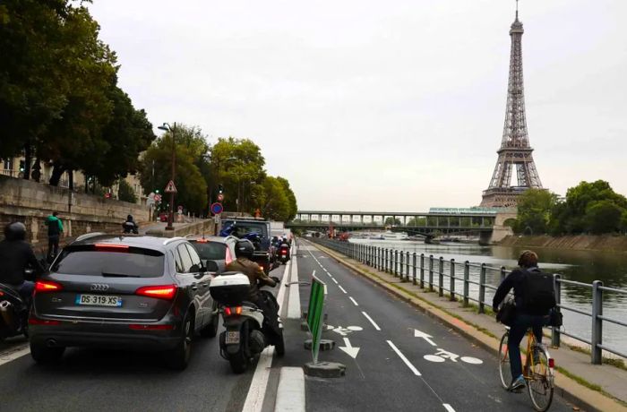 A cyclist rides past the gridlocked traffic along the Seine River in Paris.