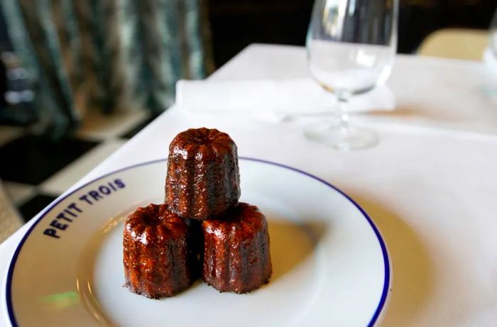 A delicious canelé at Petit Trois. This petite French pastry boasts a soft center with a crispy, caramelized exterior.