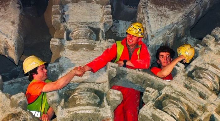 In 1991, French and British workers celebrated after a massive drilling machine finally broke through the last section of the tunnel.