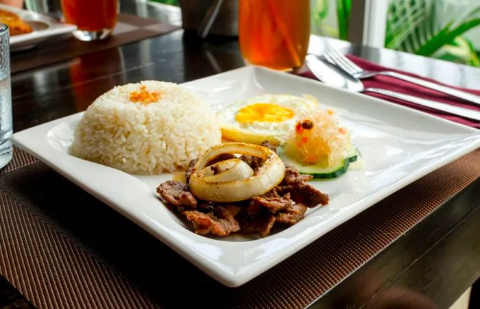 No matter the type of protein, this breakfast is typically accompanied by salted tomatoes, sawsawan (vinegar for dipping), and sometimes a touch of banana ketchup.