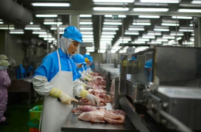 In this photo, taken on August 28, 2018, cuts of meat are processed at a Spam factory in Jincheon, South Korea.