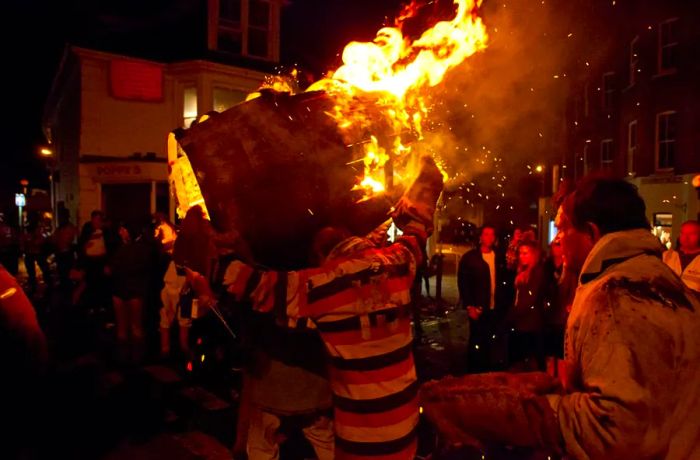 A photo capturing a past tar barrel run in Ottery St Mary, Devon, England.