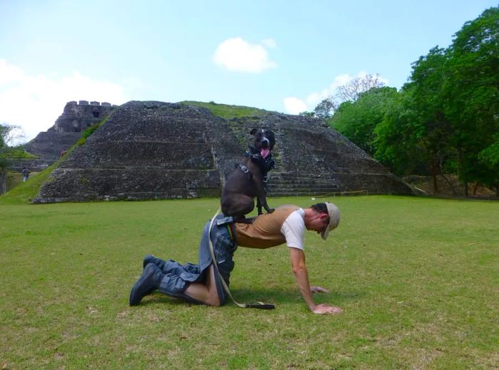 Skyla, their beloved dog, who is seen with Stu in Belize in 2014, tragically passed away a few months into their trip.